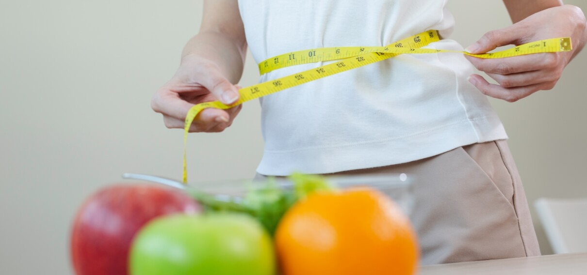 woman-measures-her-waist-size-with-tape-measure-wi-2023-11-27-04-51-55-utc (1)